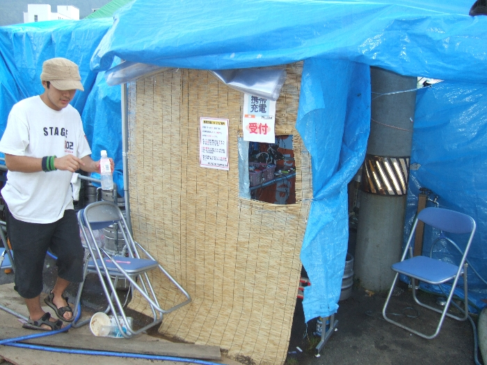 金六の店の裏。携帯電話の充電受付。