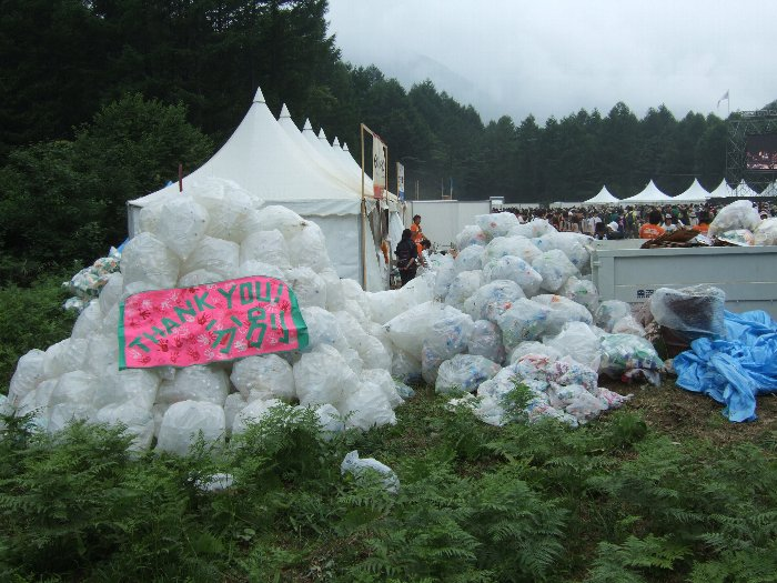 ホワイト・ステージのテントの隣に山積みされたペットボトルの袋。PR用の掲示も準備されていました。