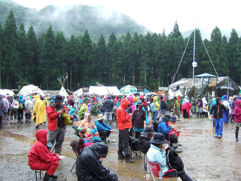 後方で座っている人。