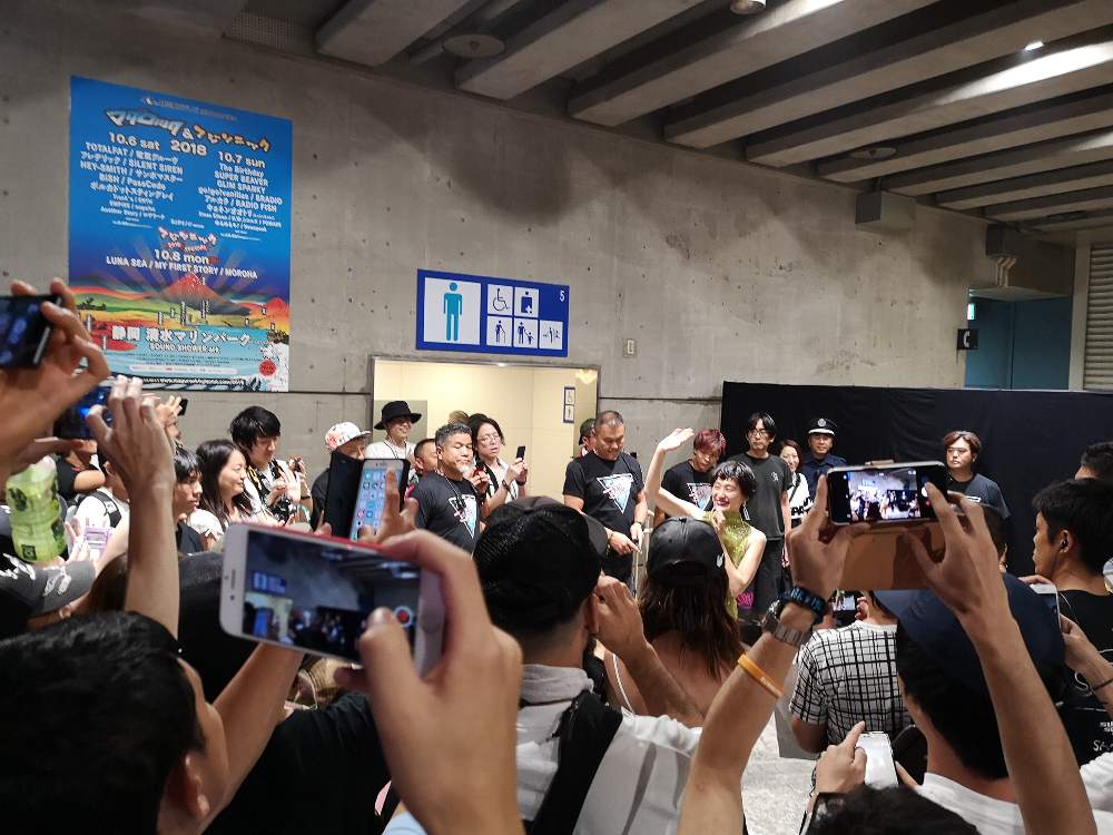 客の最後方まで行き、そのまま幕張メッセの飲食スペースを歩くという演出。大勢のファンが一緒に歩いて行きました。